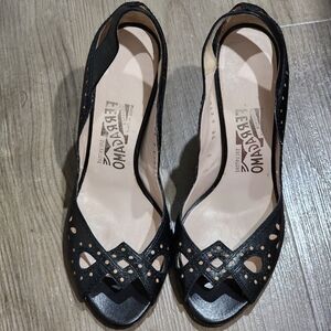 Salvatore Ferragamo black heels with peep toe.